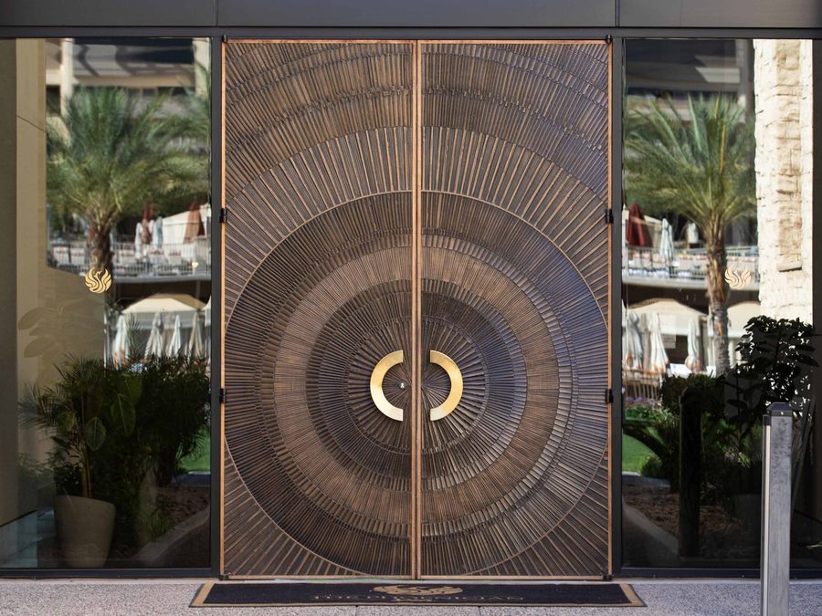 Bonded metal entrance doors in bronze