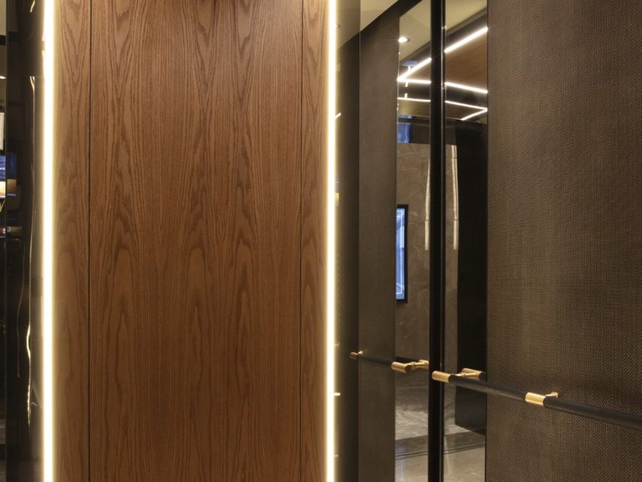 Elevator cabin lined in wood and metal