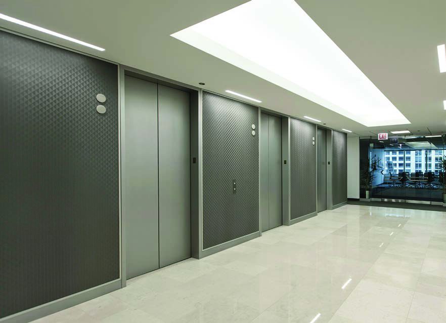 Bank of lifts with bonded metal surrounds and doors